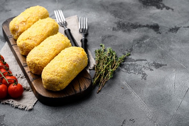 Chicken rissoles and ingredients set, on gray stone table background, with copy space for text