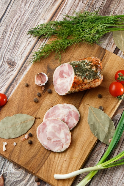 Chicken roll in grid decorated lettuce leaf isolated on wooden