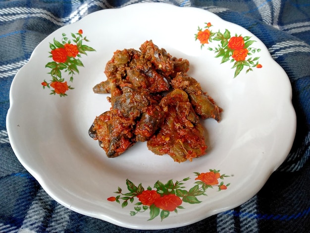 Chicken's liver with spicy chili sauce on the plate Indonesian culinary Food