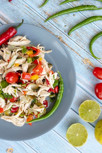 Chicken salad on blue wooden background healthy food