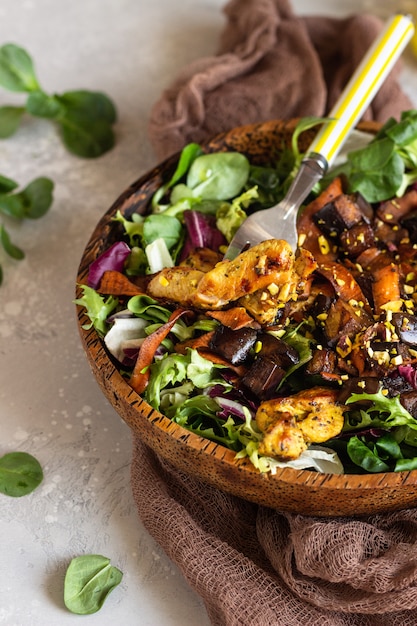 Chicken salad with eggplant, carrot and green mix salad. 