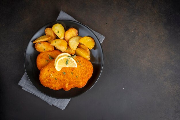 Premium Photo Cheese balls with garlic and dill inside for a snack in a plate on a black background.