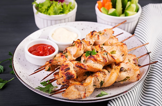 Chicken shish kebab. Shashlik - grilled meat and fresh vegetables.