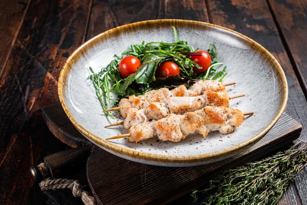 チキン串スブラキ、焼き肉シシカバブ串。木製の背景。上面図。