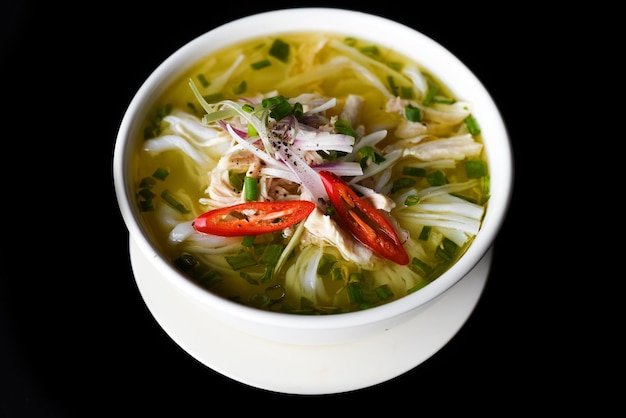 Chicken soup in vietnamese style on black background