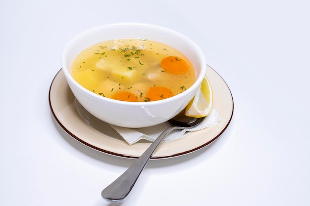 Chicken soup in a white bowl Vegetable broth Restaurant menu Deep bowl of soup with broth with vegetables and meat Vegetarian dish without meat