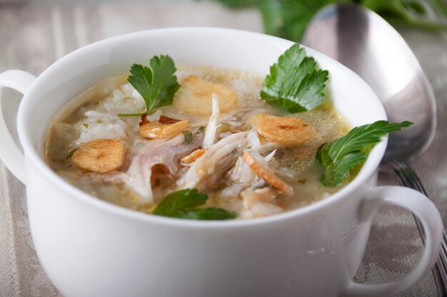 Chicken soup with rice and garlic chips