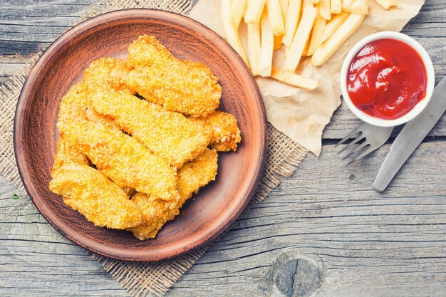 chicken strips on rustic wooden background top view