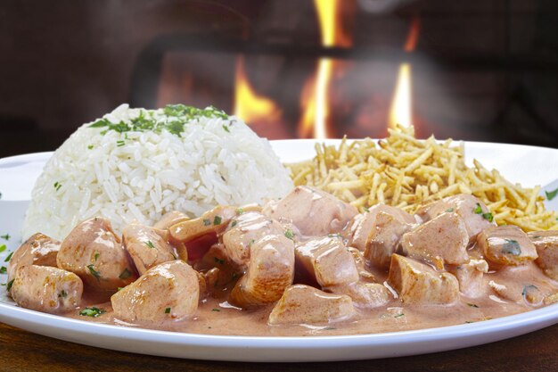 Chicken stroganoff with straw potatoes and rice