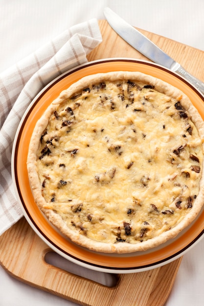 Chicken tart with mushrooms and cheese on a plate