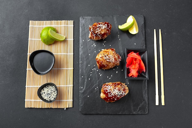 Chicken teriyaki on a black background asian food on a slate teriyaki chicken is a traditional japan