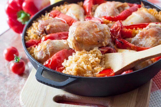 Chicken thighs and legs baked over a bed of rice and red bell pepper