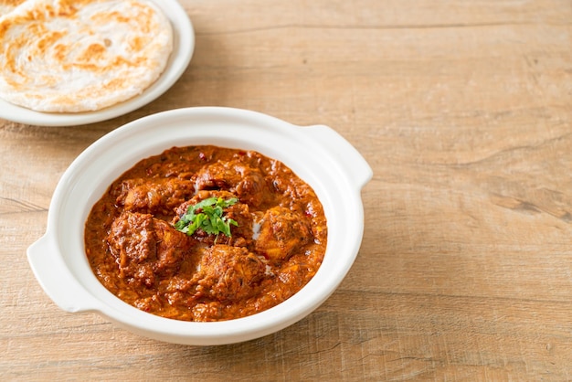 Chicken tikka masala spicy curry meat food with roti or naan bread