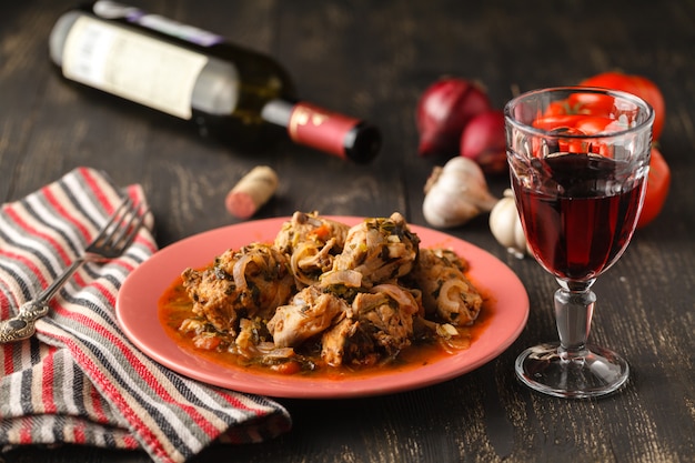 Chicken in tomato sauce in a bowl chakhokhbili