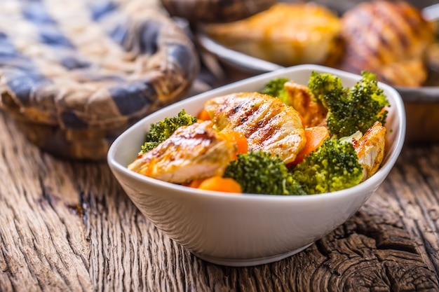 Chicken and vegetable salad. Pieces of grilled chicken with carrots and broccoli.