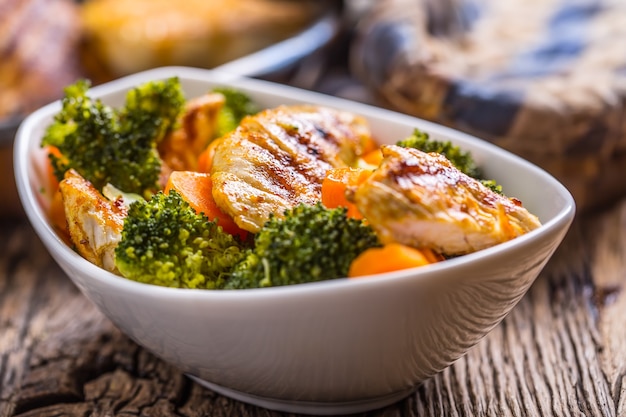 Chicken and vegetable salad. Pieces of grilled chicken with carrots and broccoli.