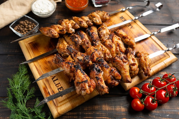 Chicken wings cooked on skewers on wooden