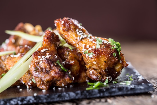 Chicken wings. Fried chicken wings in white bowl garlic dressing ketchup and potato fries.