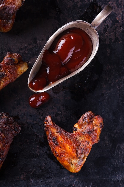 Chicken wings fried on the grill with BBQ sauce