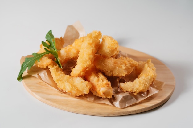 Chicken wings with salad on wooden board side view