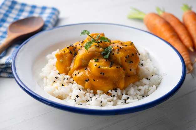 Chicken with carrot sauce and curry. Traditional Asian recipe.