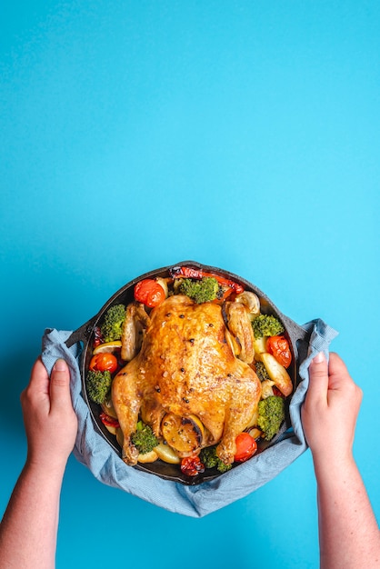 Chicken with vegetables baked in an iron cast.