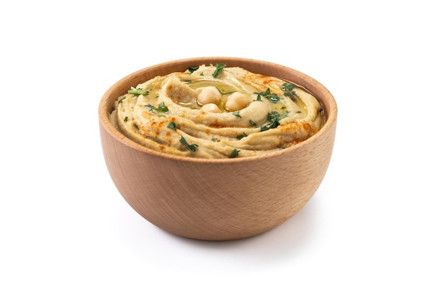 Photo chickpea hummus in a wooden bowl garnished with parsley paprika and olive oil isolated on white background