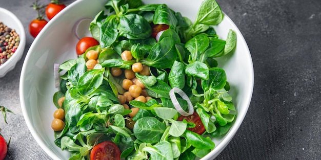 chickpea salad legumes, lettuce, mache, tomato fresh healthy meal food snack diet on the table