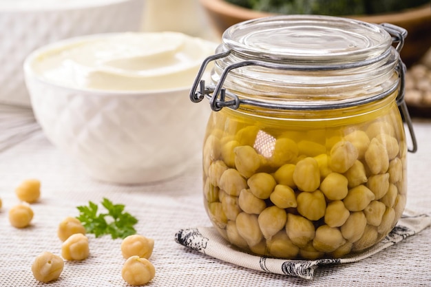 Chickpeas in compote with aquafaba and vegan mayonnaise in the background