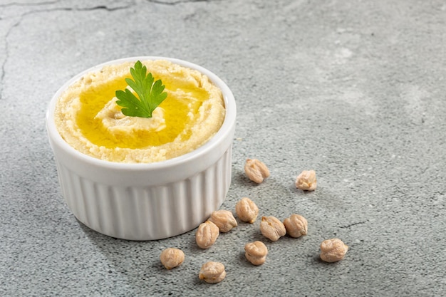 Chickpeas hummus with olive oil in the bowl