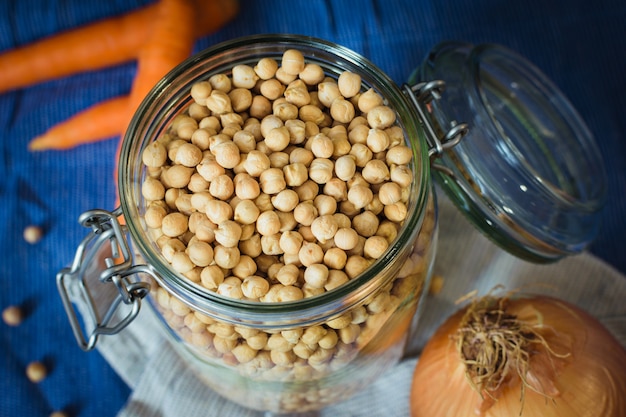 Chickpeas jar. Carrots, onion, ingresients of mediterranean food. Legume background