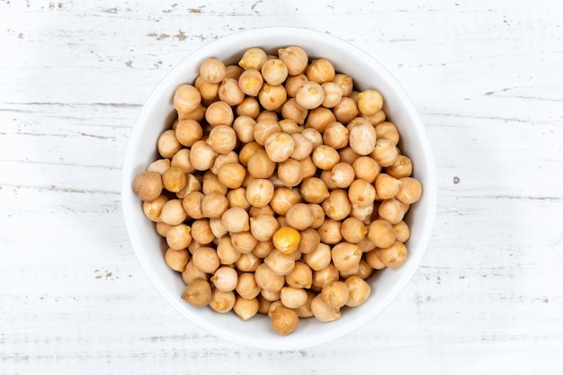 Chickpeas peas raw from above bowl wooden board