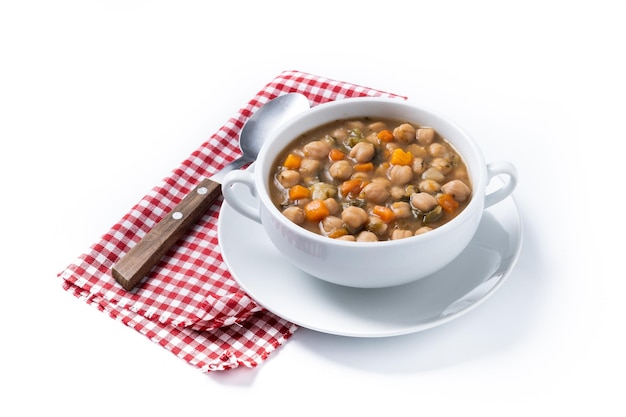 Chickpeas soup with vegetables in bowl isolated on white background