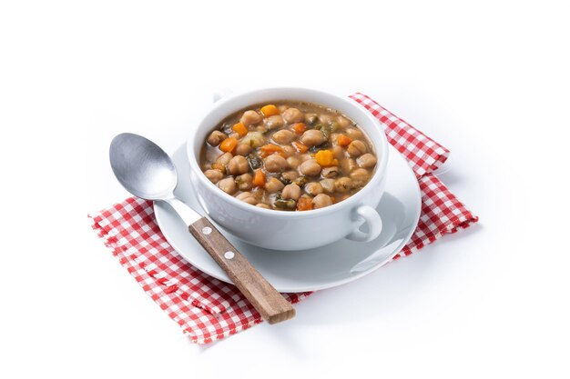 Chickpeas soup with vegetables in bowl isolated on white background