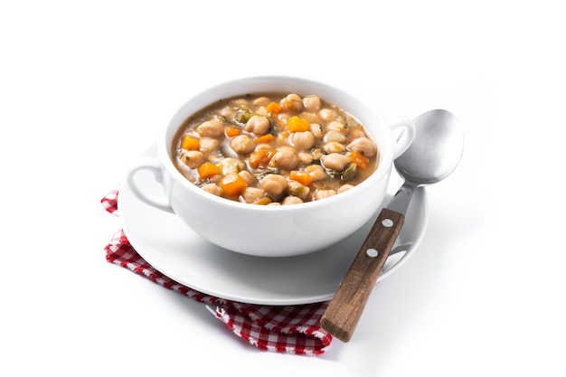 Chickpeas soup with vegetables in bowl isolated on white background