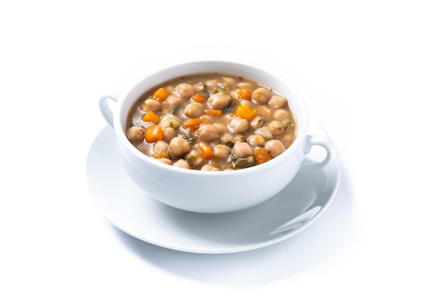 Chickpeas soup with vegetables in bowl on wooden table