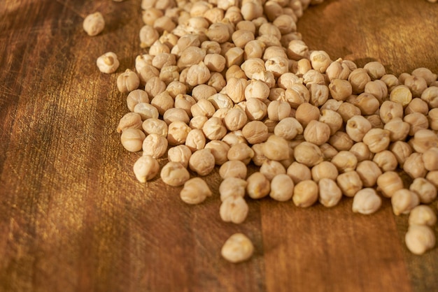 Chickpeas on a wooden surface in daylight.