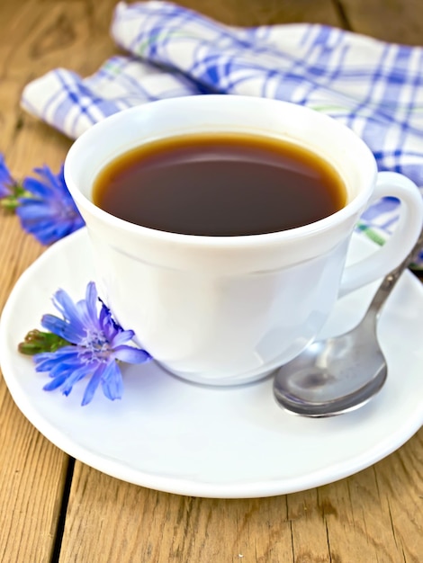 Chicory drink in white cup with flower on board