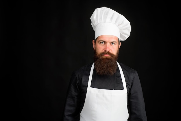 Chief cook and professional culinary bearded man in kitchen apron chef cook or baker man bearded man