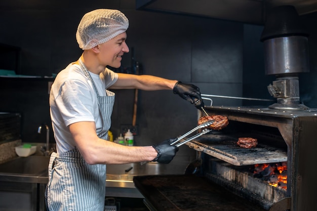 A chiefcooker working in the kitchen in the restaurant