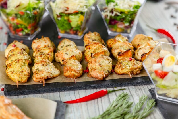 Chikrn kebabs on wooden table