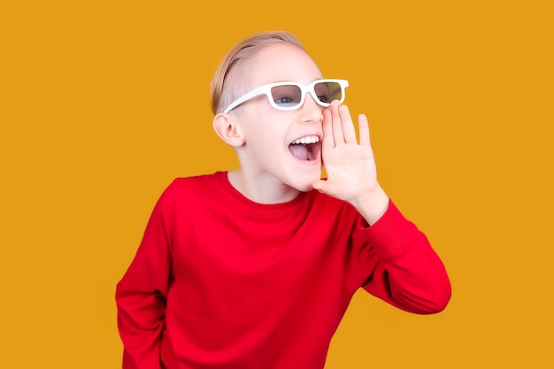 A child in 3D glasses puts his hand to his mouth and screams