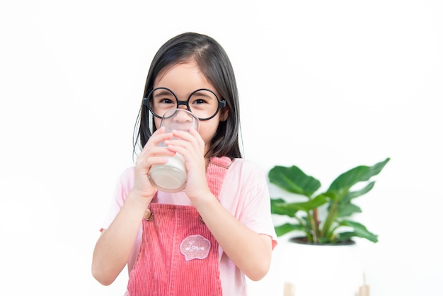 Child asia girl drink milk with a glass