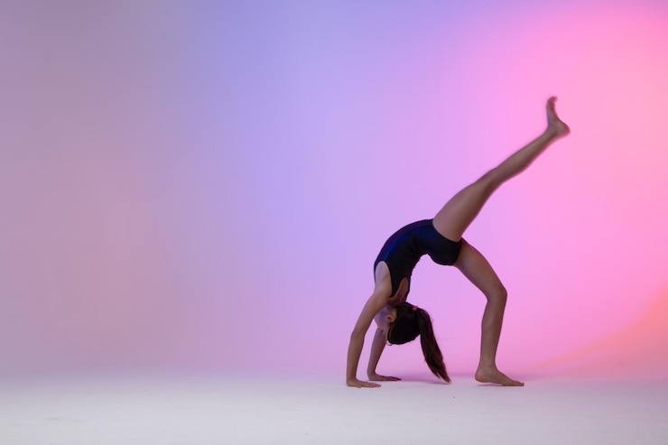 Photo child athlete gymnast performing gymnastic exercises on the floor training for competition