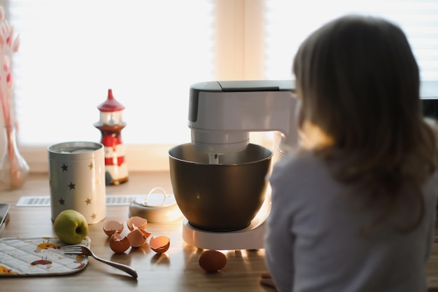 Child baking pie in a cozy kitchen at home