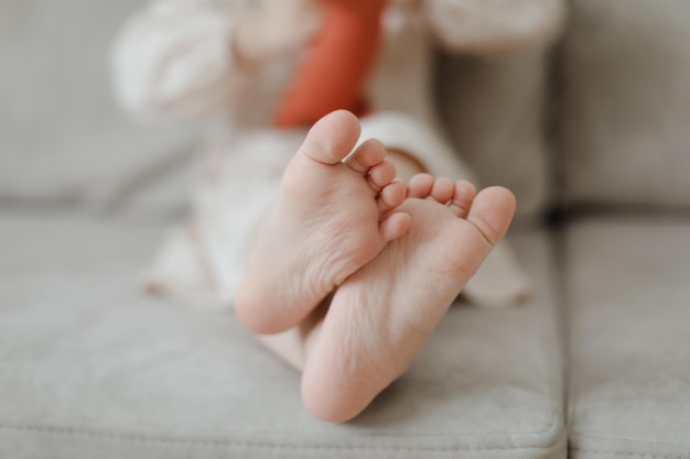 Child bare little feet closeup indoors child sitting barefoot