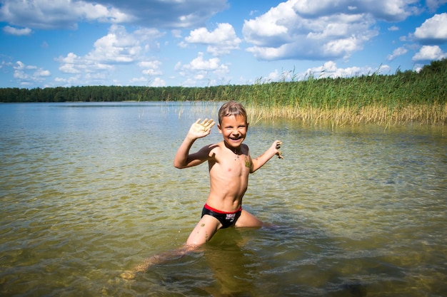 child bathes in the lake