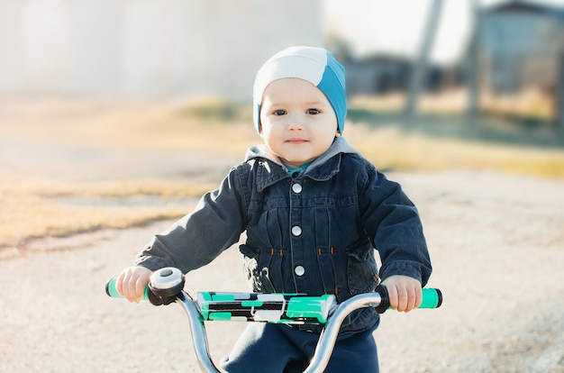 Child on a bike, in the spring cute little athlete