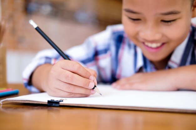 Child boy drawing picture at home.