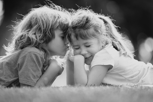 Child boy and girl hugging each other with love in the spring garden two little kids hugging in the